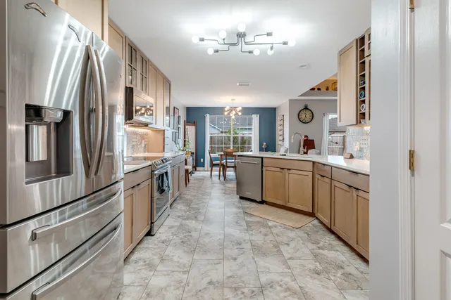 a kitchen with stainless steel appliances a sink stove and refrigerator
