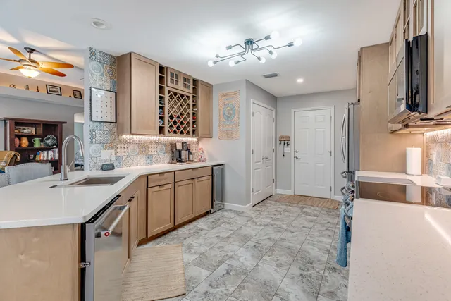 a kitchen with granite countertop a stove and a sink