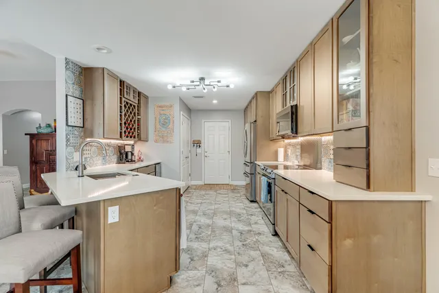 a view of a refrigerator in kitchen and white cabinets
