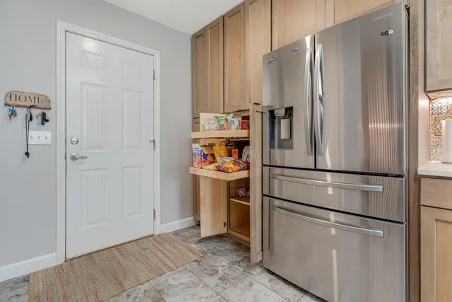 a kitchen with a sink a counter and a clock on the wall
