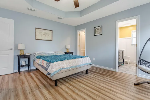 a bathroom with a granite countertop sink a toilet and mirror