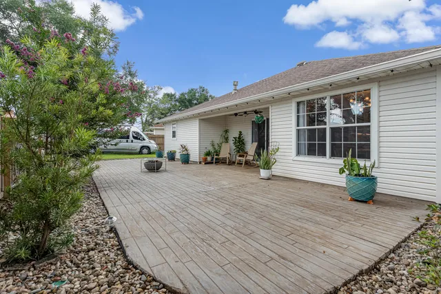 a view of backyard with tub and deck
