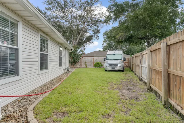 an aerial view of a houses with a yard