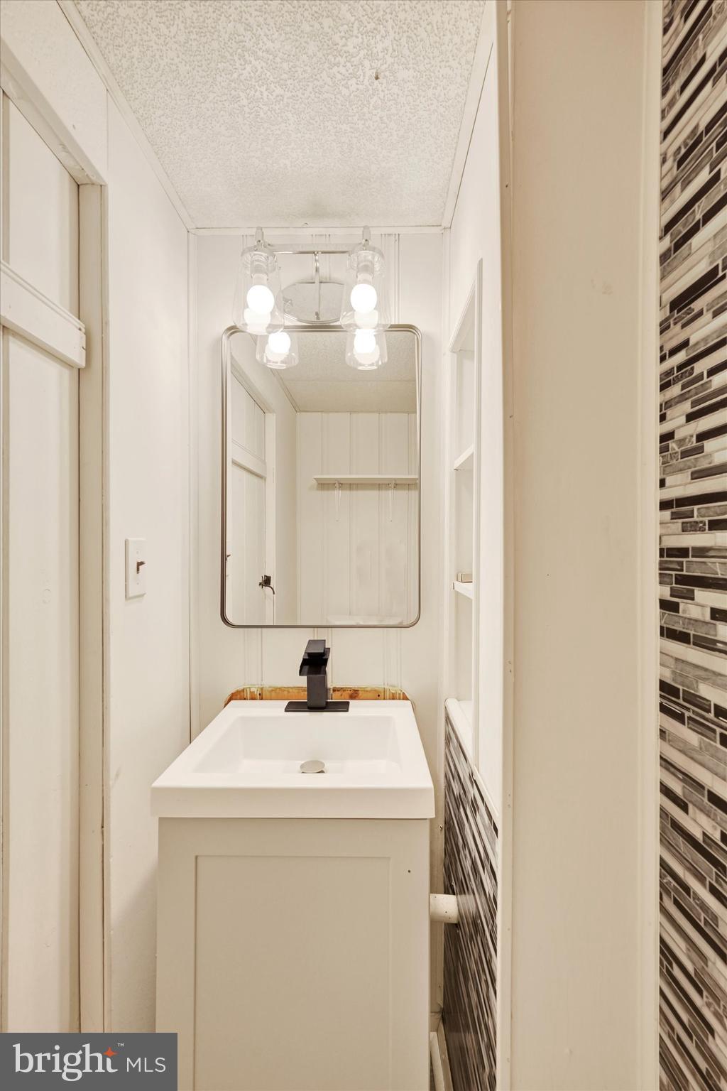 1945 Ormand Road Baltimore, MD 21222 - Photo 23 of 28 a bathroom with a sink and a mirror
