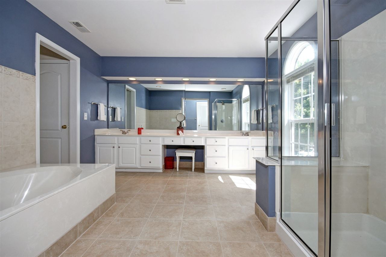 7532 Silver View Lane Raleigh, NC 27613 - Photo 16 of 30 HUGE owner's suite with very big his and her closets, so much counter space, storage, dual vanities, tile surround soaker tub and stand alone shower. Master Bathroom