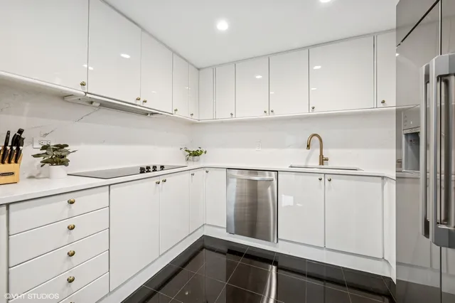 a kitchen with white cabinets and white appliances
