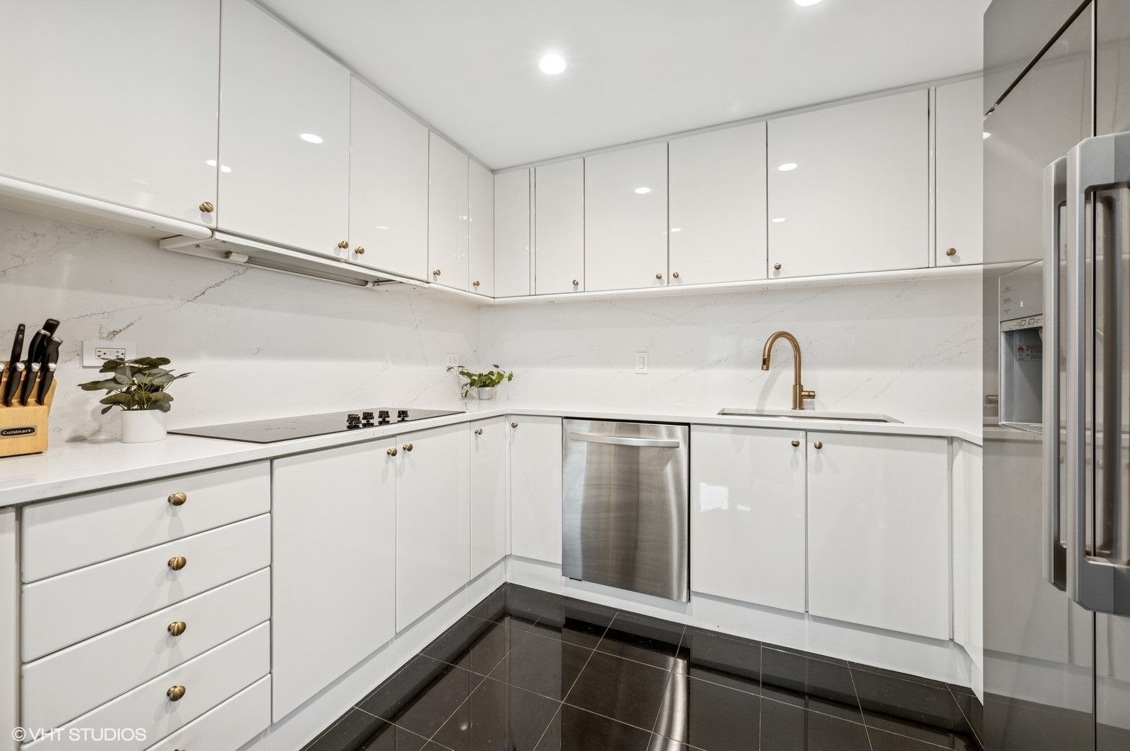 100 East Huron Street, Unit 3501 Chicago, IL 60611 - Photo 11 of 30 a kitchen with white cabinets and white appliances