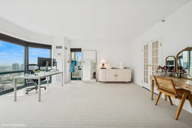 a view of a livingroom with workspace and a couch