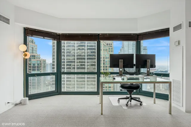 a living room with furniture a rug and a flat screen tv