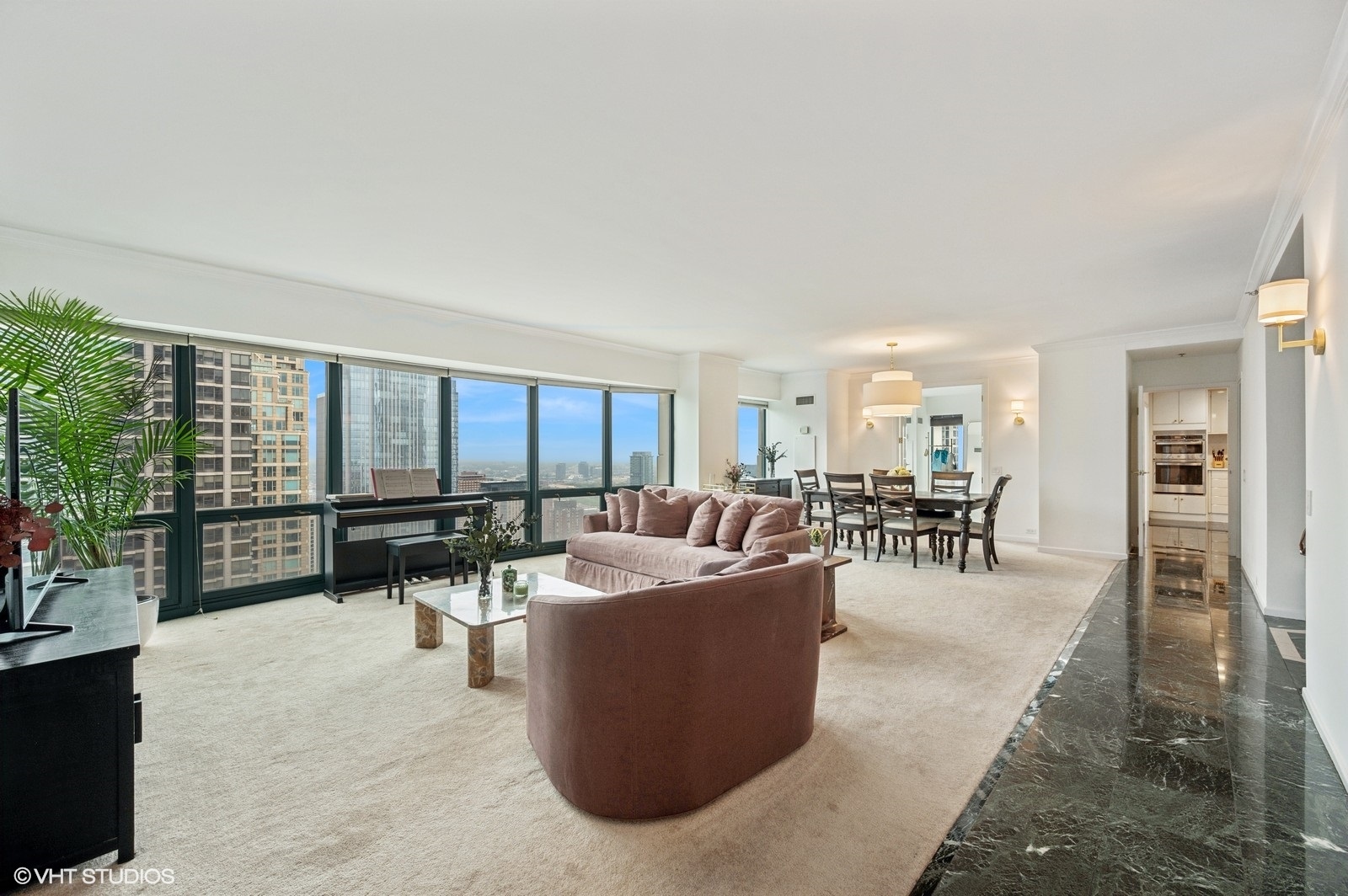 100 East Huron Street, Unit 3501 Chicago, IL 60611 - Photo 2 of 30 a living room with furniture a rug a potted plant and a large window