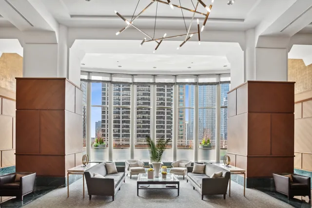 a living room with furniture and large windows