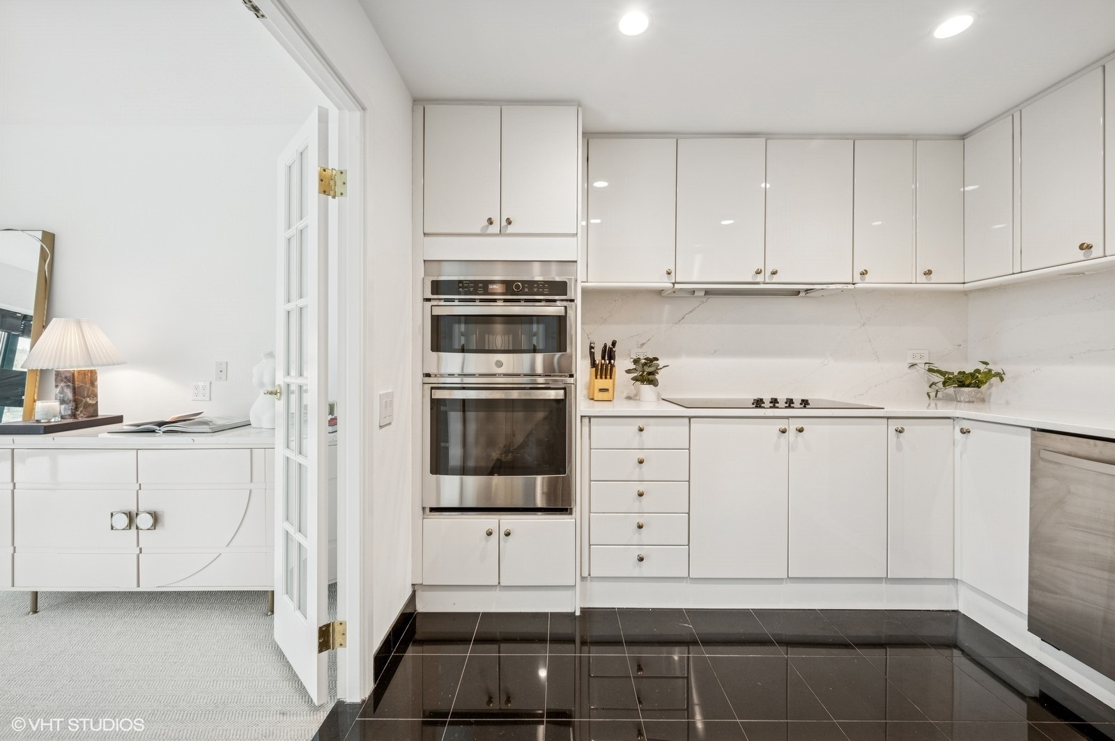 100 East Huron Street, Unit 3501 Chicago, IL 60611 - Photo 4 of 30 a kitchen with white cabinets and white appliances
