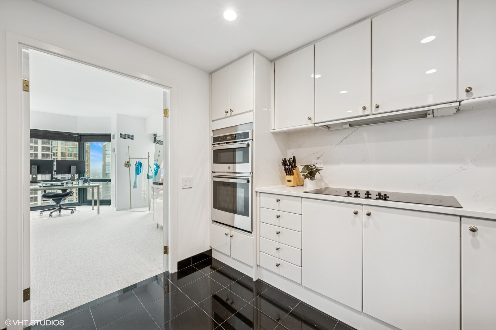 100 East Huron Street, Unit 3501 Chicago, IL 60611 - Photo 5 of 30 a kitchen with granite countertop white cabinets and white appliances