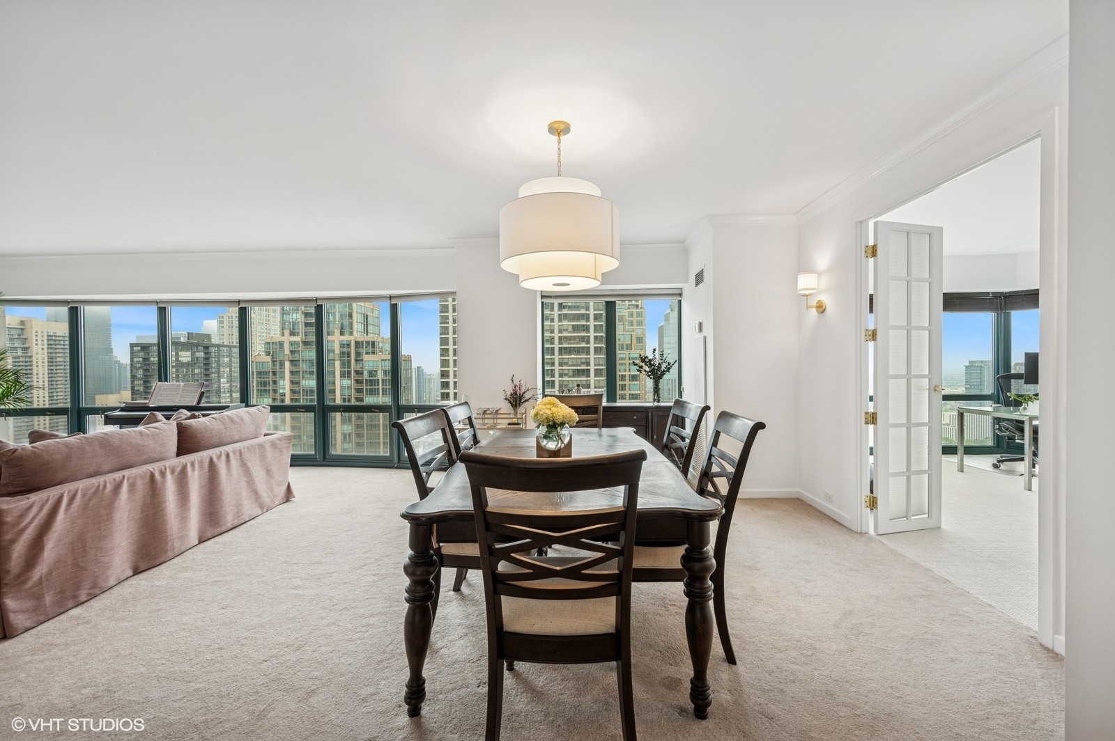 100 East Huron Street, Unit 3501 Chicago, IL 60611 - Photo 7 of 30 a dining room with furniture wooden floor and a chandelier