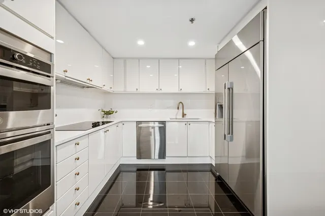 a kitchen with white cabinets and white appliances