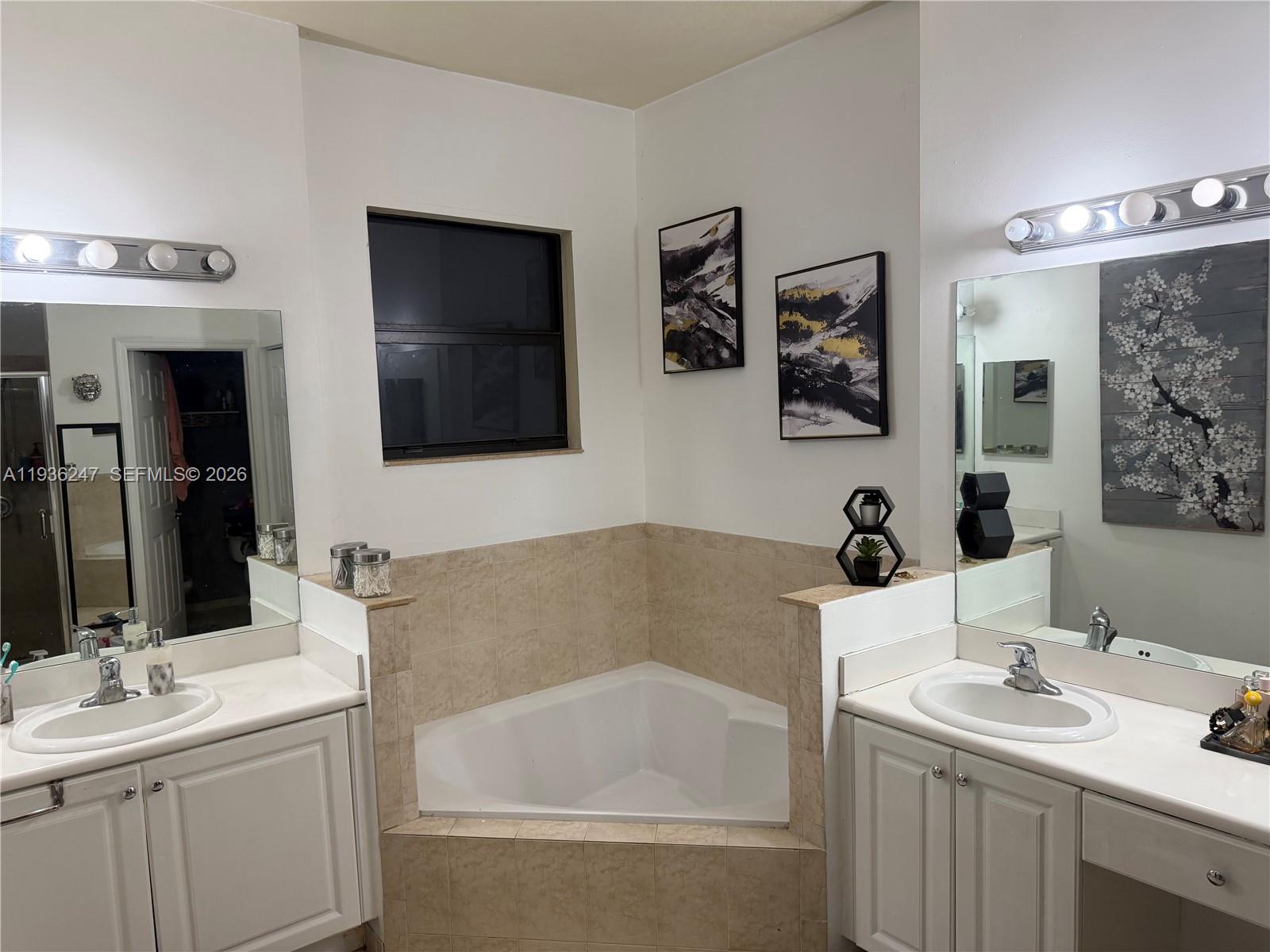 685 Southeast 37th Place Homestead, FL 33033 - Photo 9 of 11 a bathroom with a tub sink and mirror