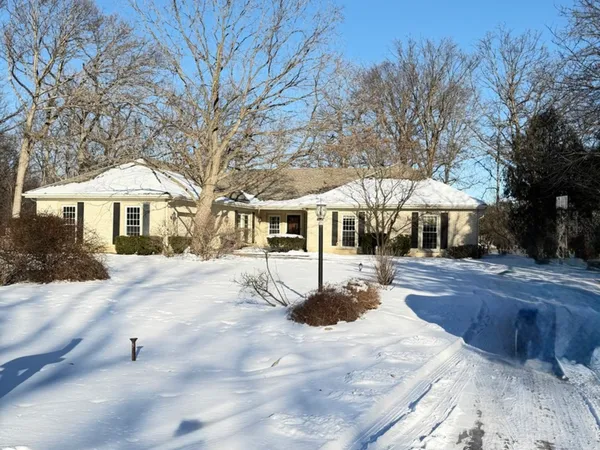 a front view of a house with yard and tree s
