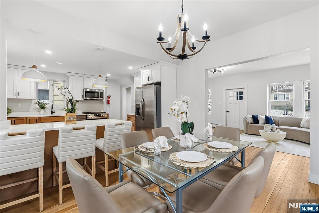 33 Robertson Road West Orange, NJ 07052 - Photo 12 of 48 a view of a dining room and livingroom with furniture wooden floor a chandelier