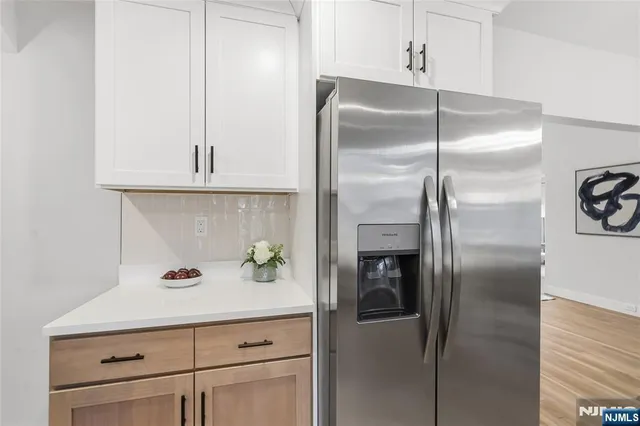 a kitchen with a refrigerator and cabinets