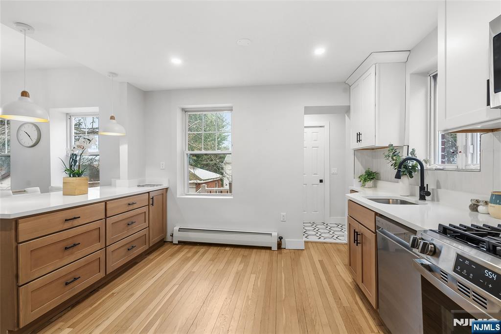 33 Robertson Road West Orange, NJ 07052 - Photo 19 of 48 a kitchen with a sink and wooden floor