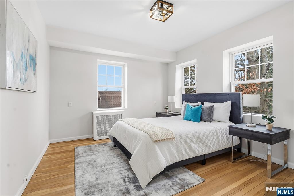 33 Robertson Road West Orange, NJ 07052 - Photo 21 of 48 a bedroom with a bed and wooden floor