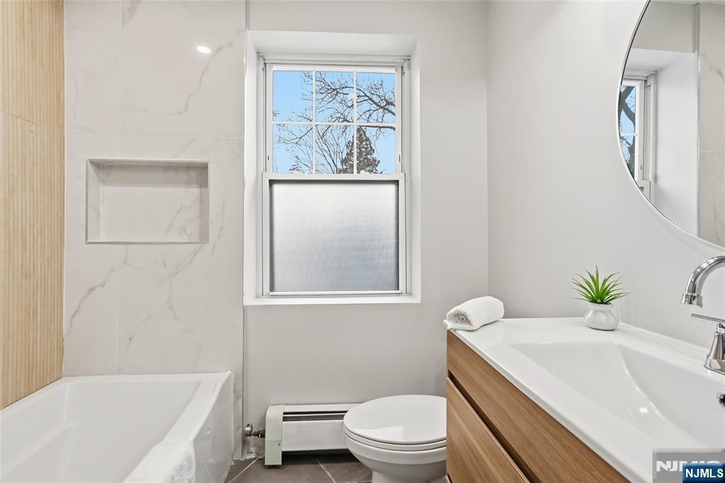 33 Robertson Road West Orange, NJ 07052 - Photo 24 of 48 a bath room with a toilet a sink and a bath tub