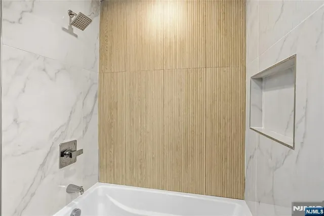 a bathroom with a bathtub and shower
