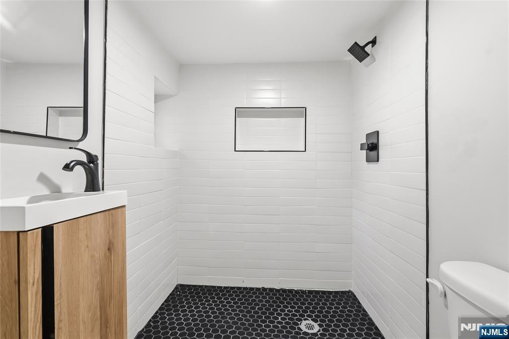 33 Robertson Road West Orange, NJ 07052 - Photo 27 of 48 a bathroom with a sink toilet and shower