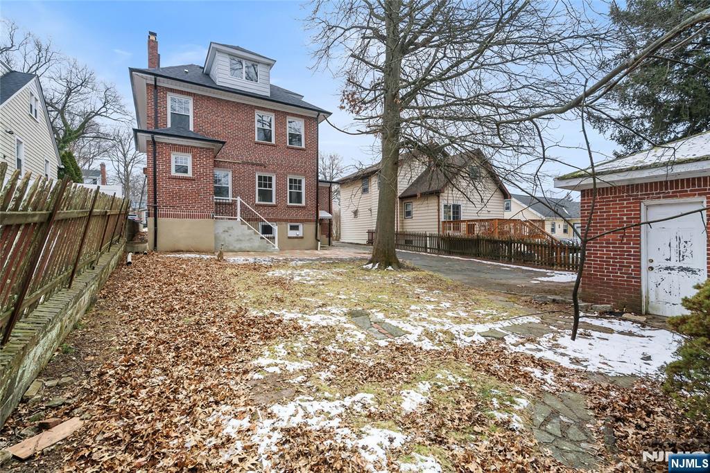 33 Robertson Road West Orange, NJ 07052 - Photo 37 of 48 a front view of a house with a yard covered with snow
