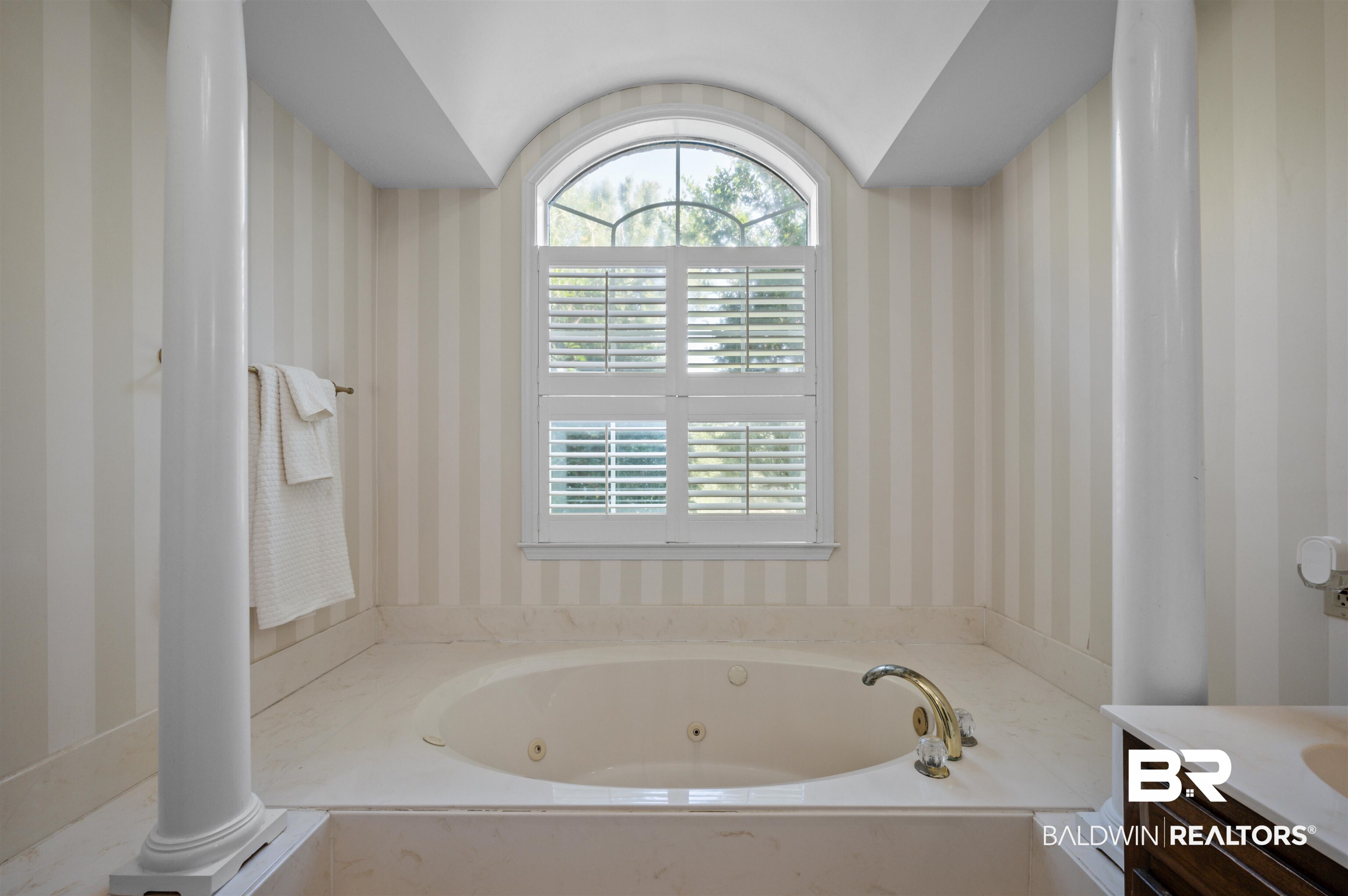 141 Blue Ridge Drive Monroeville, AL 36460 - Photo 26 of 40 Full bathroom with wallpapered walls, a tub with jets, vanity, and plenty of natural light