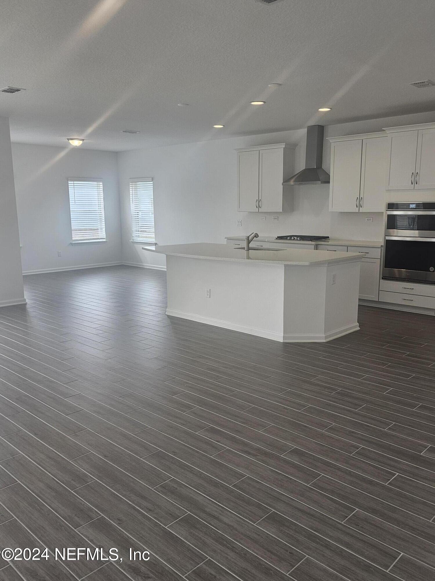 183 Bluegrass Way St. Augustine, FL 32092 - Photo 3 of 9 a view of kitchen with kitchen island wooden floors wooden cabinets and stainless steel appliances