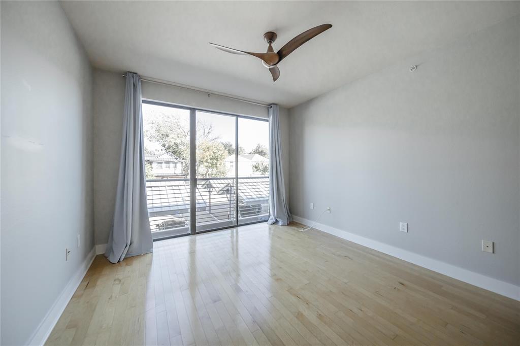 4414 Cedar Springs Road, Unit 214 Dallas, TX 75219 - Photo 10 of 29 Unfurnished room with ceiling fan and light wood-type flooring