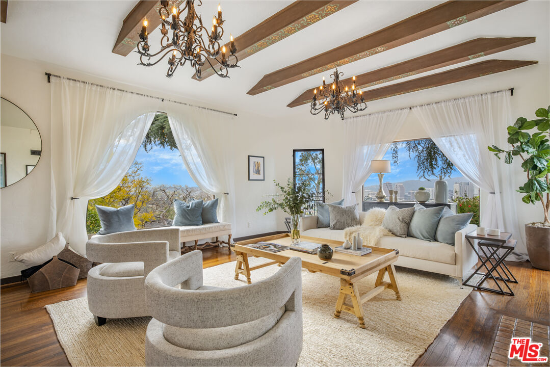 a living room with furniture and a chandelier