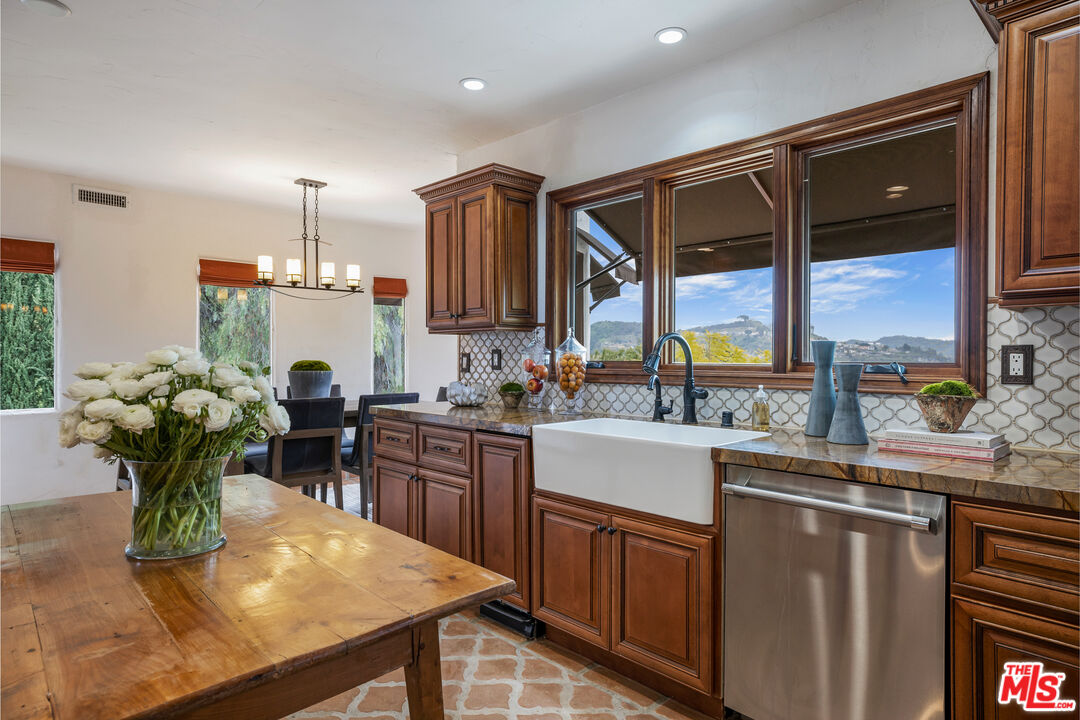 861 Cavanagh Road Glendale, CA 91207 - Photo 7 of 21 a kitchen with stainless steel appliances granite countertop sink stove and wooden cabinets