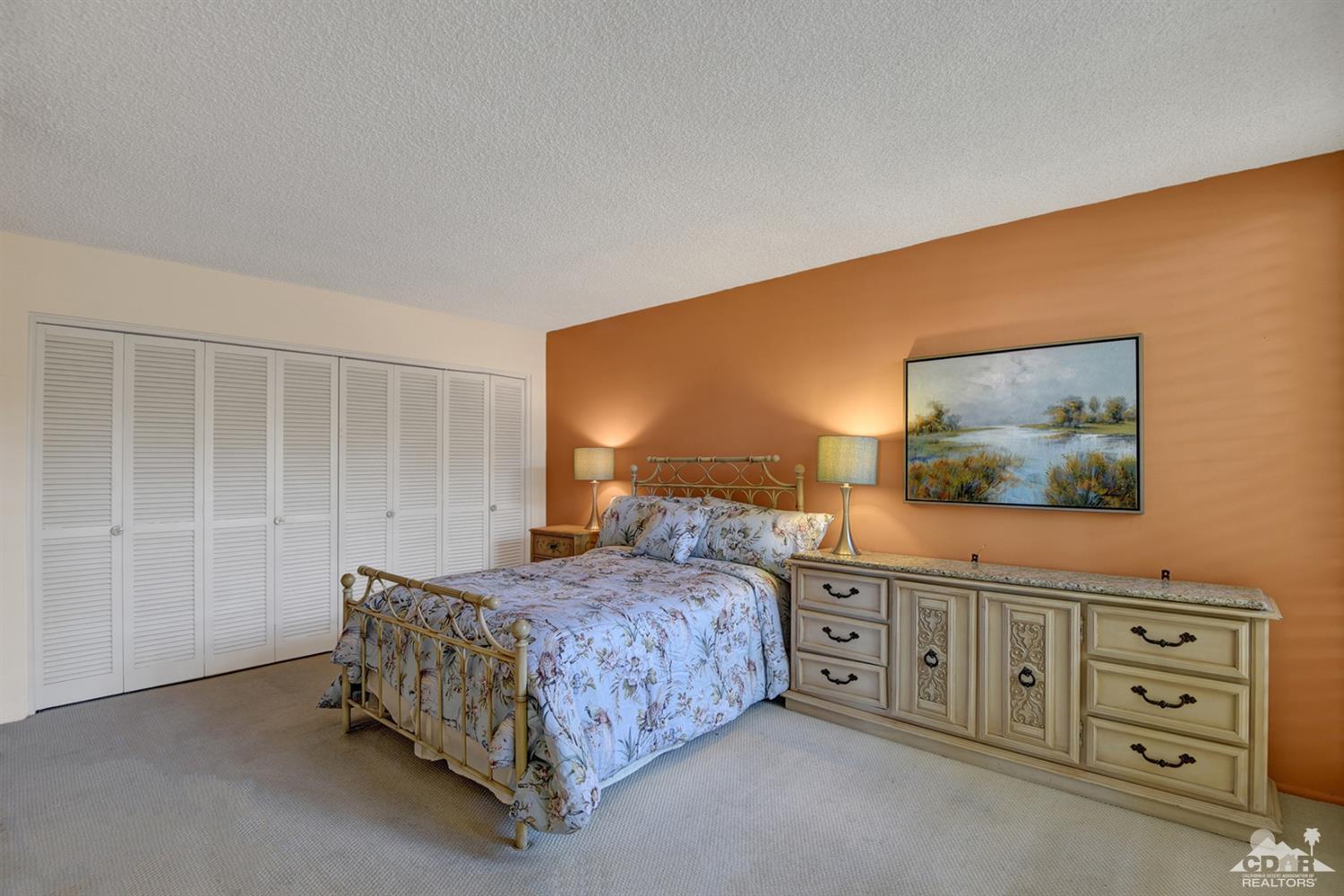 42278 Dunes View Road, Unit 27 Rancho Mirage, CA 92270 - Photo 12 of 20 a bedroom with a bed and a cabinets