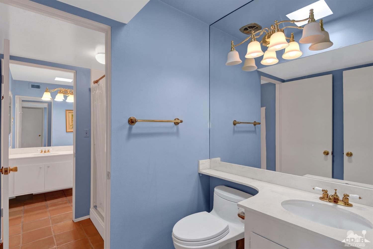 42278 Dunes View Road, Unit 27 Rancho Mirage, CA 92270 - Photo 16 of 20 a bathroom with a toilet sink and mirror