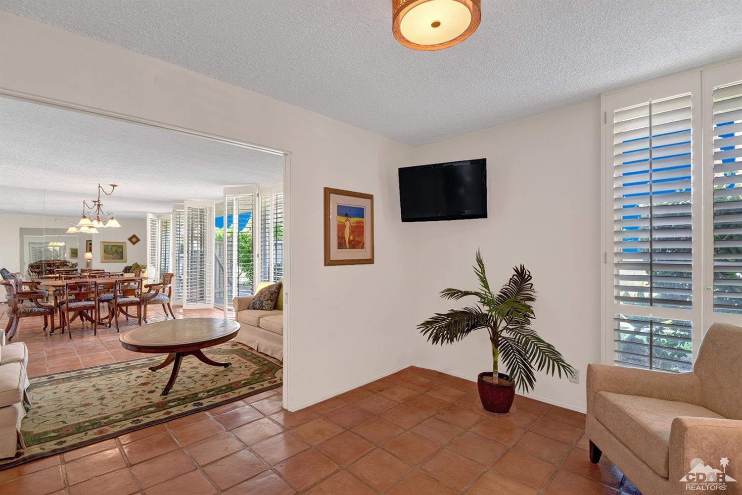 42278 Dunes View Road, Unit 27 Rancho Mirage, CA 92270 - Photo 5 of 20 a living room with furniture and a flat screen tv