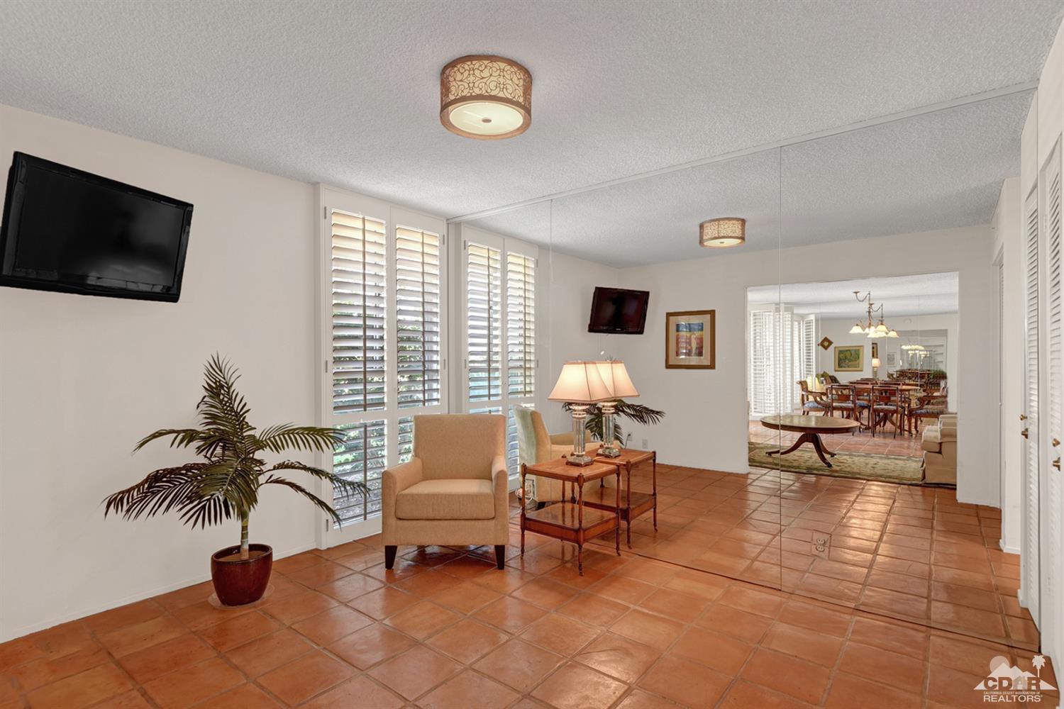 42278 Dunes View Road, Unit 27 Rancho Mirage, CA 92270 - Photo 6 of 20 a living room with furniture and a flat screen tv