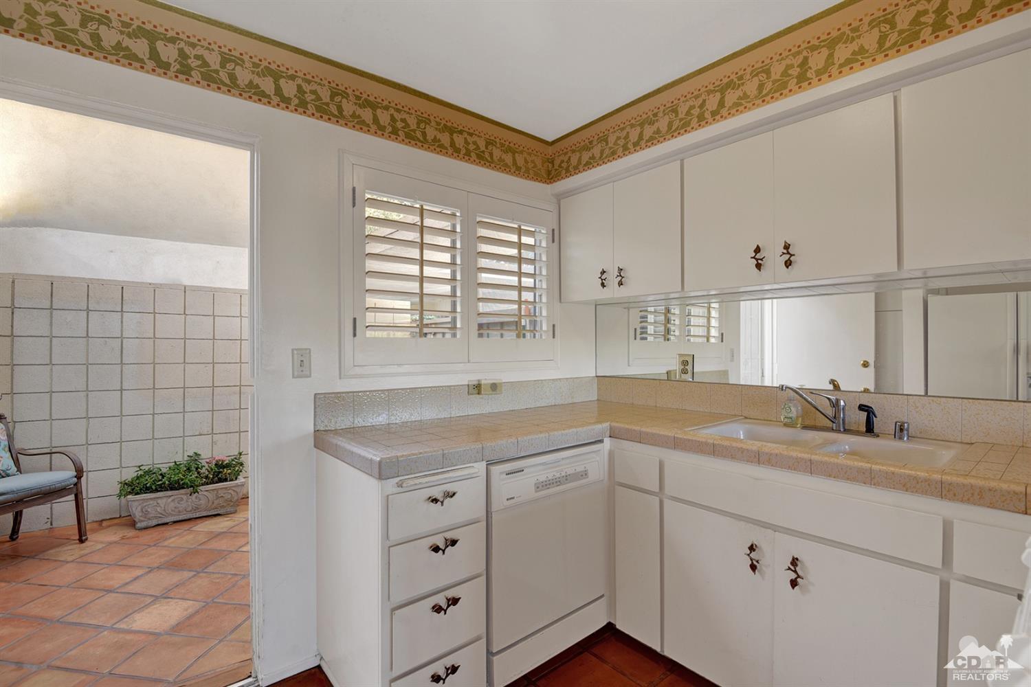 42278 Dunes View Road, Unit 27 Rancho Mirage, CA 92270 - Photo 10 of 20 a kitchen with a sink and cabinets