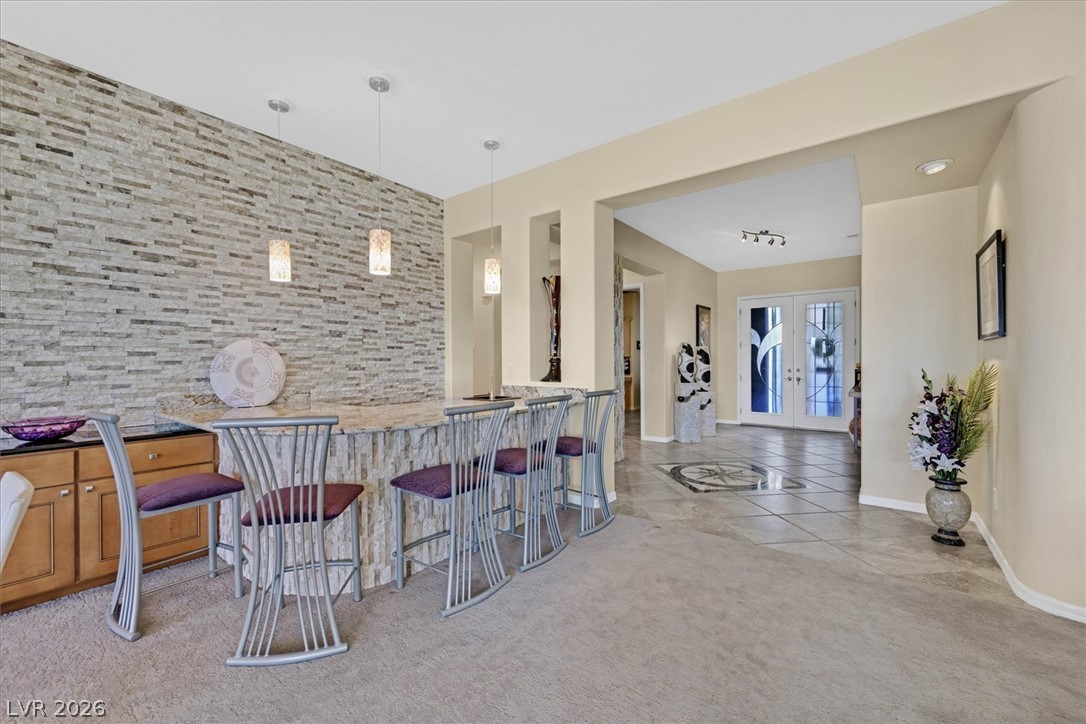 1823 Baton Rouge Street Henderson, NV 89052 - Photo 9 of 60 An inviting stone-faced bar connects seamlessly to the tiled entryway beyond.