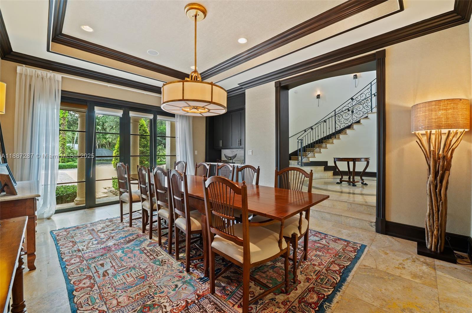 9601 Southwest 60th Court Pinecrest, FL 33156 - Photo 11 of 61 a dining room with furniture a chandelier and wooden floor