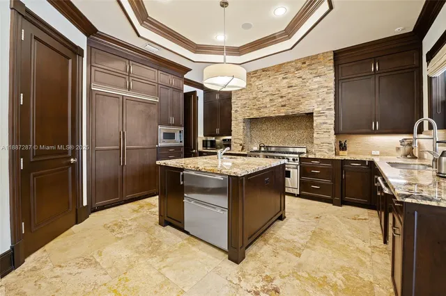 a kitchen with a stove a sink and a refrigerator