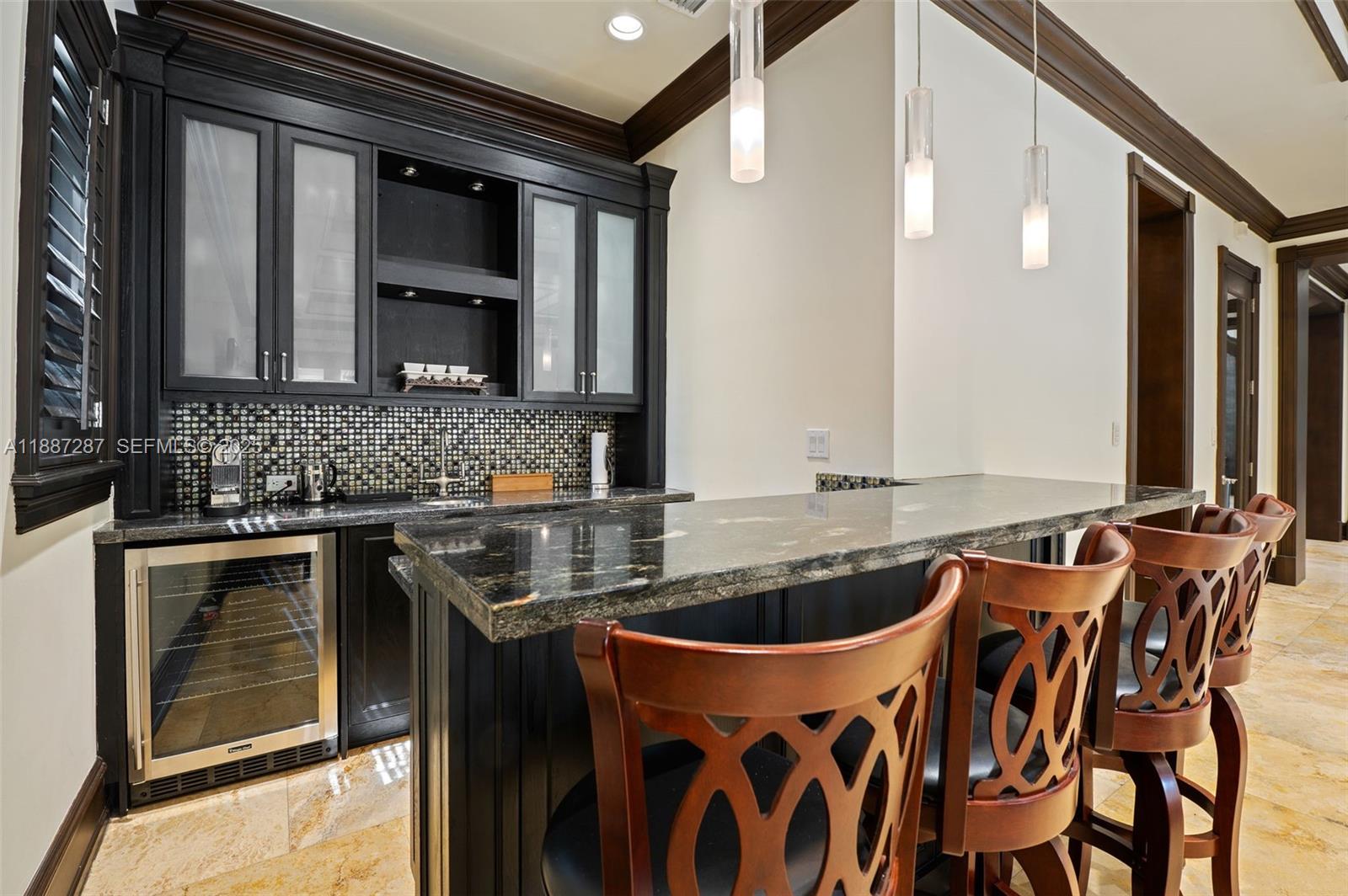 9601 Southwest 60th Court Pinecrest, FL 33156 - Photo 17 of 61 a kitchen with stainless steel appliances granite countertop a sink and a stove
