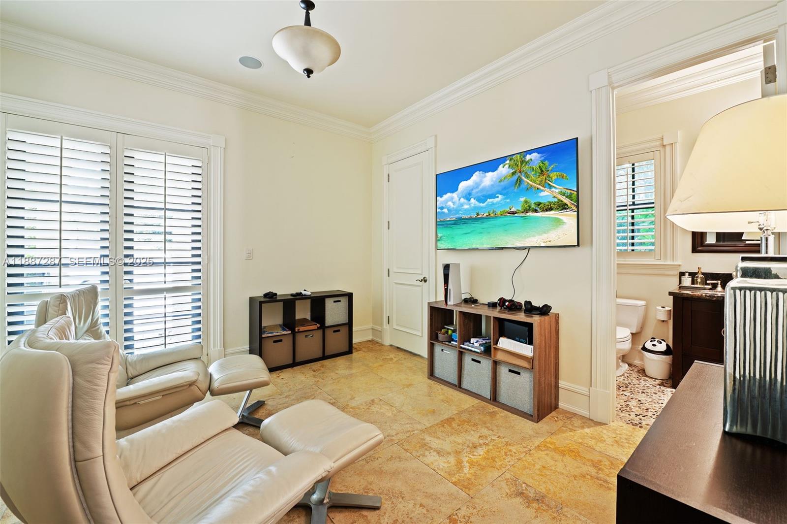 9601 Southwest 60th Court Pinecrest, FL 33156 - Photo 19 of 61 a living room with furniture and a flat screen tv