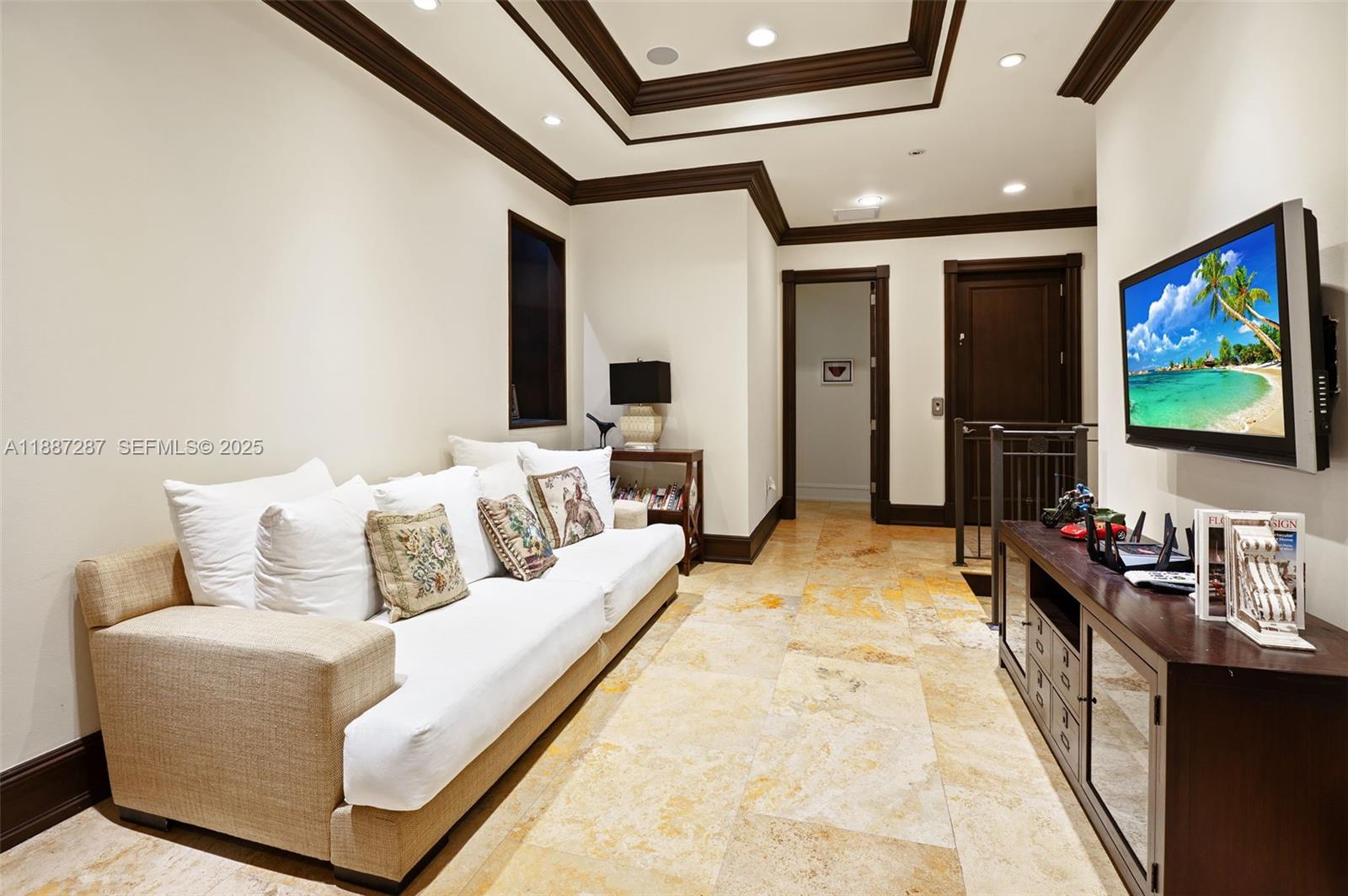 9601 Southwest 60th Court Pinecrest, FL 33156 - Photo 22 of 61 a living room with furniture and a flat screen tv