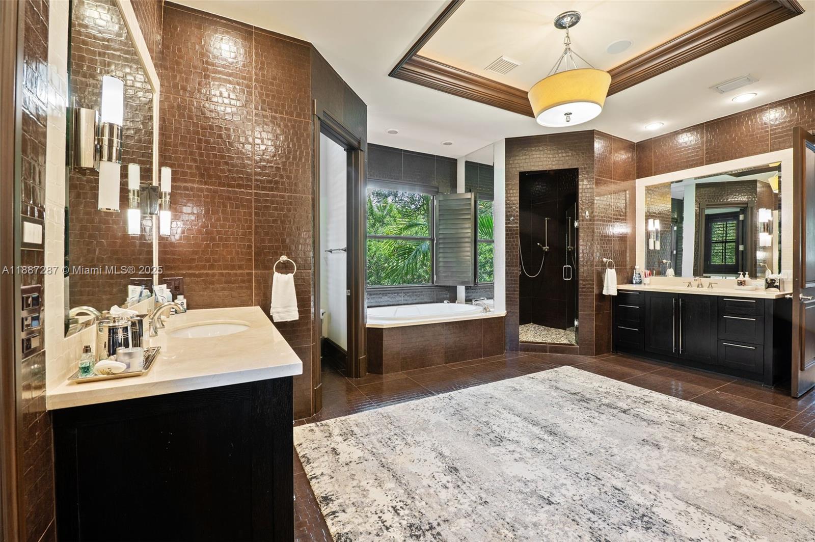 9601 Southwest 60th Court Pinecrest, FL 33156 - Photo 26 of 61 a bathroom with a sink a vanity and a large mirror