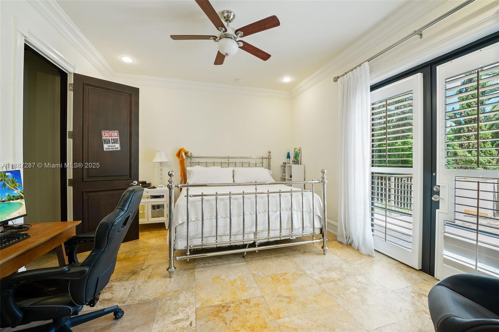 9601 Southwest 60th Court Pinecrest, FL 33156 - Photo 29 of 61 a bedroom with furniture and a window