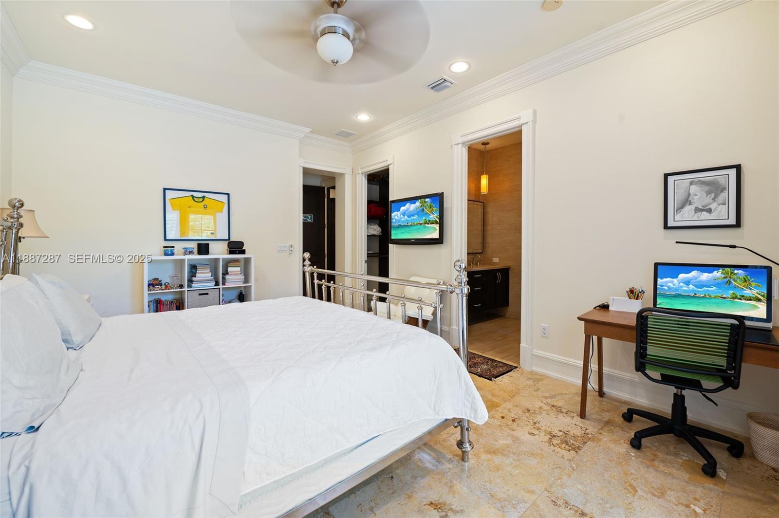 9601 Southwest 60th Court Pinecrest, FL 33156 - Photo 32 of 61 a bedroom with a bed and a flat screen tv