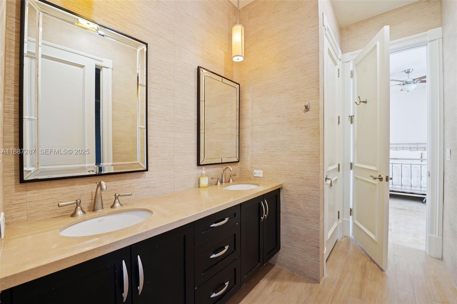 9601 Southwest 60th Court Pinecrest, FL 33156 - Photo 33 of 61 a bathroom with double sink and a mirror