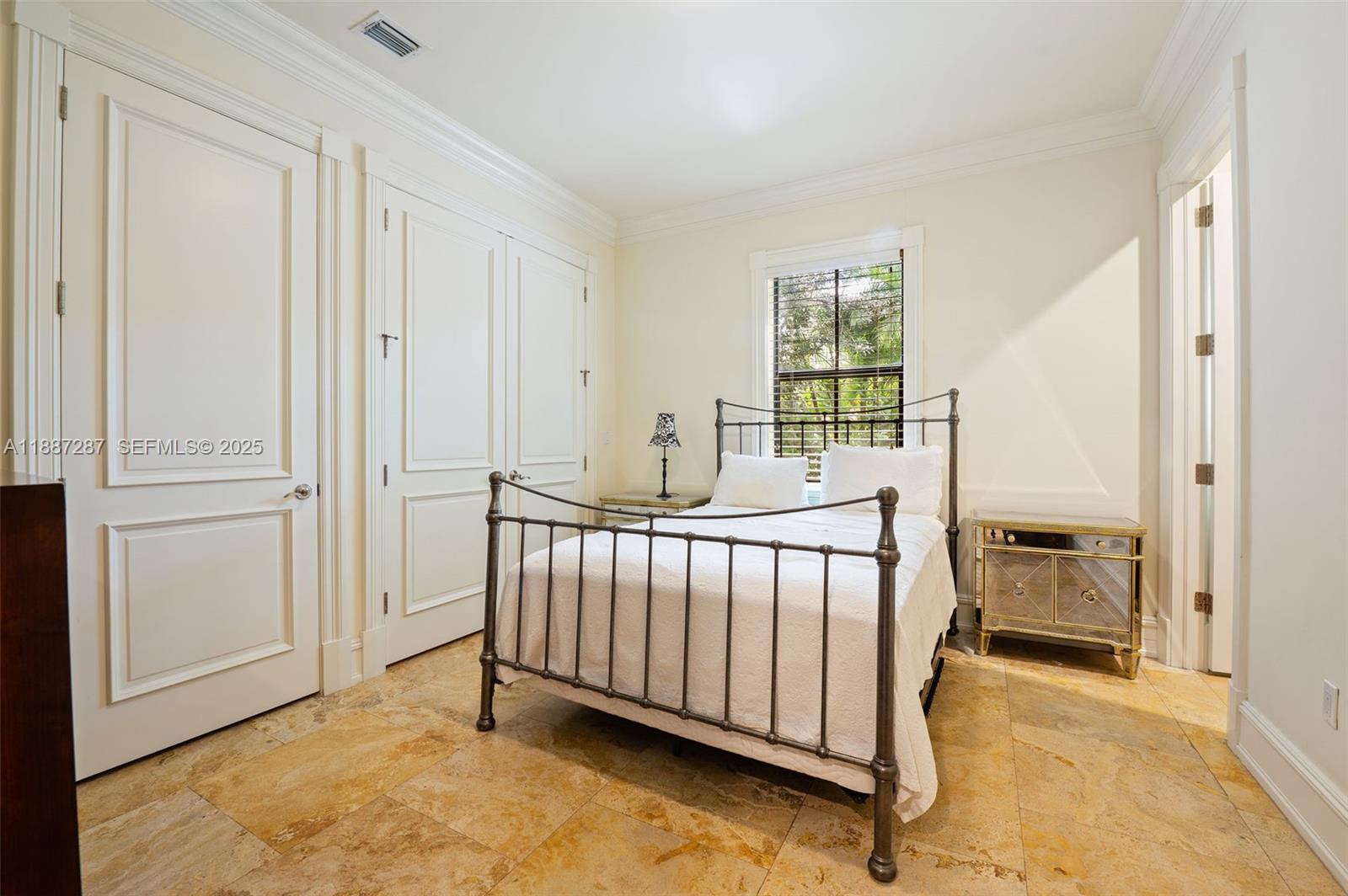 9601 Southwest 60th Court Pinecrest, FL 33156 - Photo 35 of 61 a bed room with a bed and a window